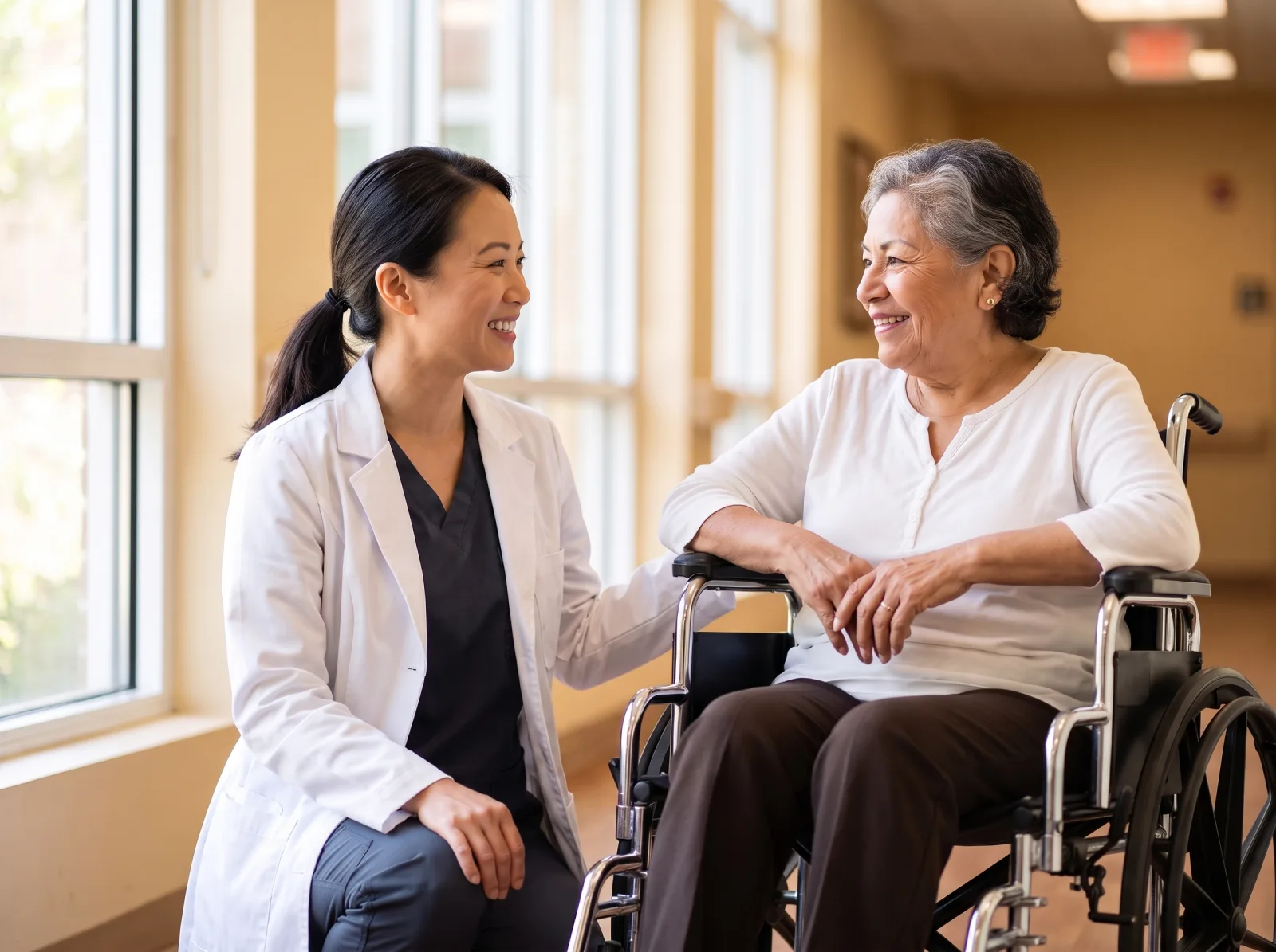 Journey Medical Group physician speaking at eye level with an elderly long-term care resident